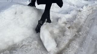 The girl is trying to walk on ice in ballet boots, but her toes are very painful