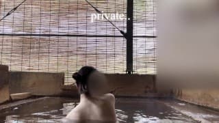 Japanese girl bathing in a mixed outdoor bath at a hot spring inn